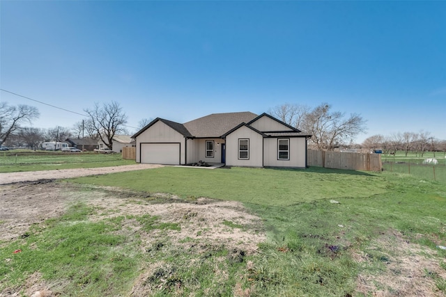 ranch-style home featuring a front yard and a garage