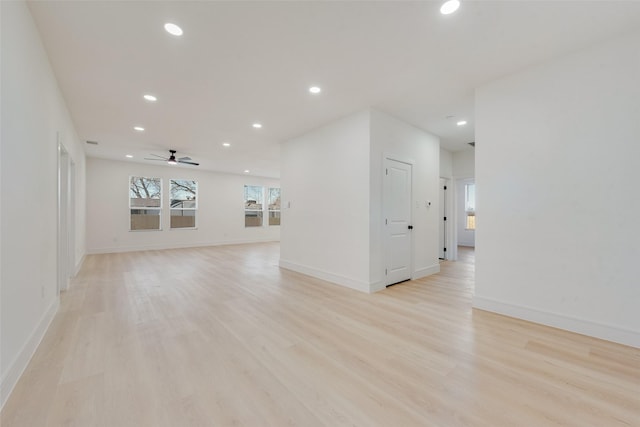 empty room with light hardwood / wood-style flooring and ceiling fan