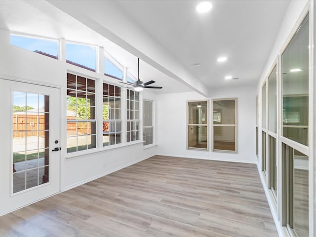 unfurnished sunroom with vaulted ceiling with beams and ceiling fan