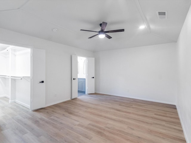 unfurnished room featuring ceiling fan, light wood-type flooring, and vaulted ceiling