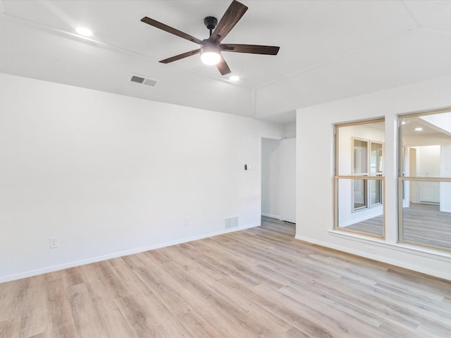 empty room with ceiling fan and light hardwood / wood-style floors