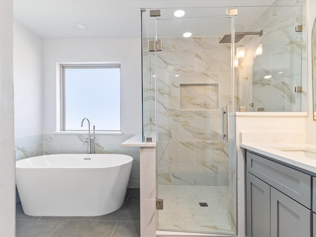 bathroom with tile patterned flooring, vanity, and independent shower and bath