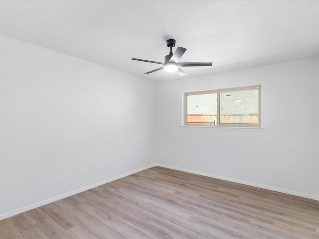 empty room featuring ceiling fan and light wood-type flooring