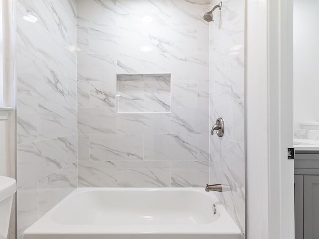 full bathroom with vanity, toilet, and tiled shower / bath