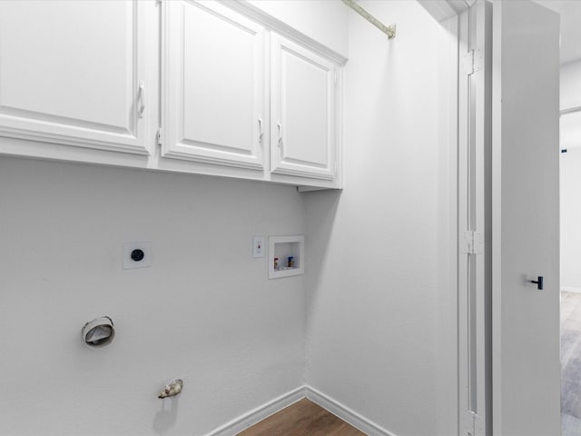 clothes washing area featuring cabinets, washer hookup, electric dryer hookup, gas dryer hookup, and wood-type flooring