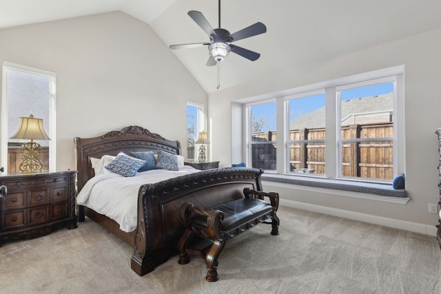 carpeted bedroom featuring ceiling fan, lofted ceiling, and multiple windows