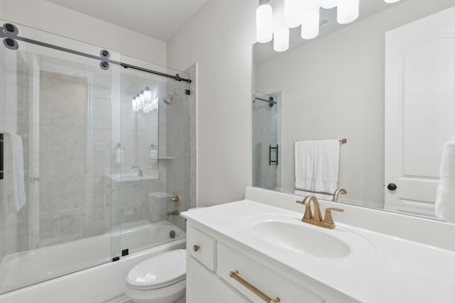 full bathroom featuring vanity, enclosed tub / shower combo, and toilet