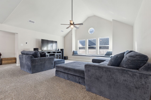 carpeted living room with ceiling fan and vaulted ceiling