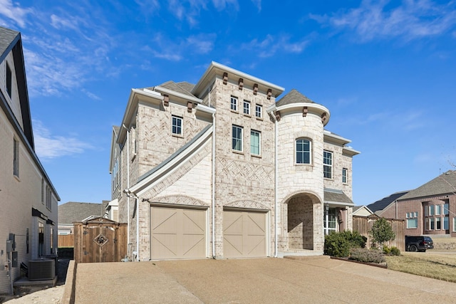 view of front of property featuring central AC and a garage