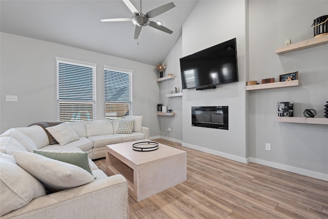 living room with ceiling fan, wood-type flooring, and vaulted ceiling