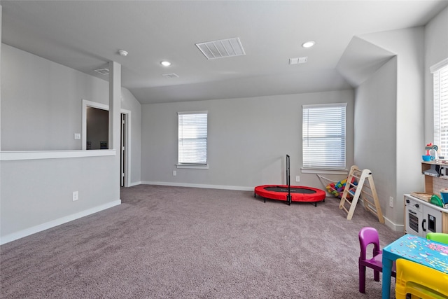 playroom with a wealth of natural light, carpet, and vaulted ceiling