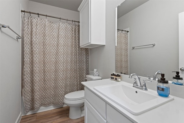 bathroom featuring vanity, hardwood / wood-style flooring, and toilet