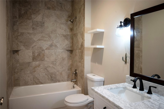 full bathroom featuring vanity, tiled shower / bath combo, and toilet