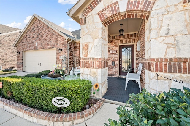 doorway to property with a garage