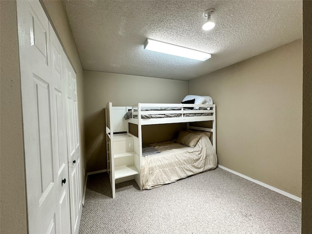 unfurnished bedroom featuring carpet and a textured ceiling