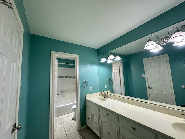 full bathroom featuring tile patterned floors, vanity, tiled shower / bath combo, and toilet