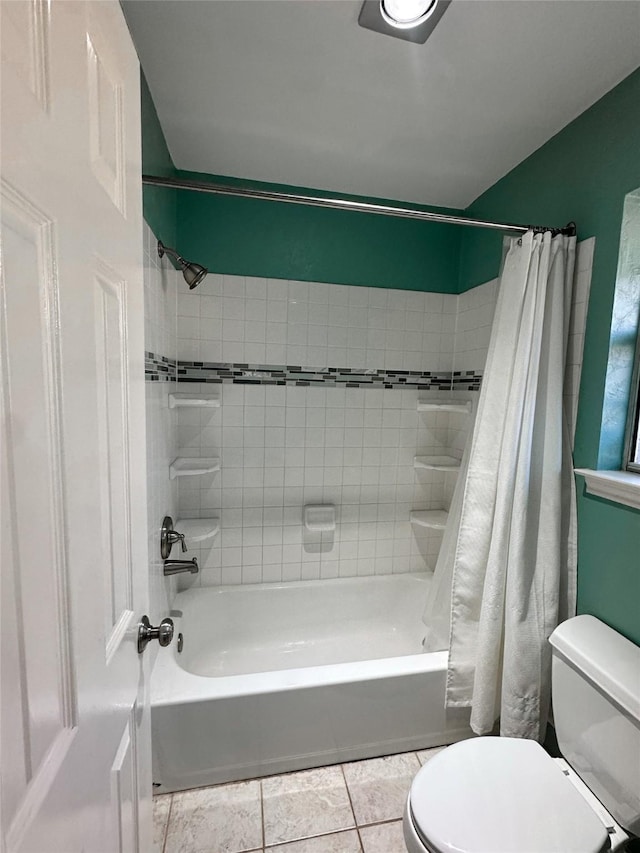 bathroom with tile patterned flooring, shower / bath combo, and toilet