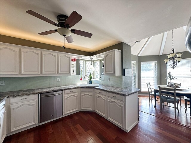 kitchen with pendant lighting, dishwasher, backsplash, sink, and white cabinetry