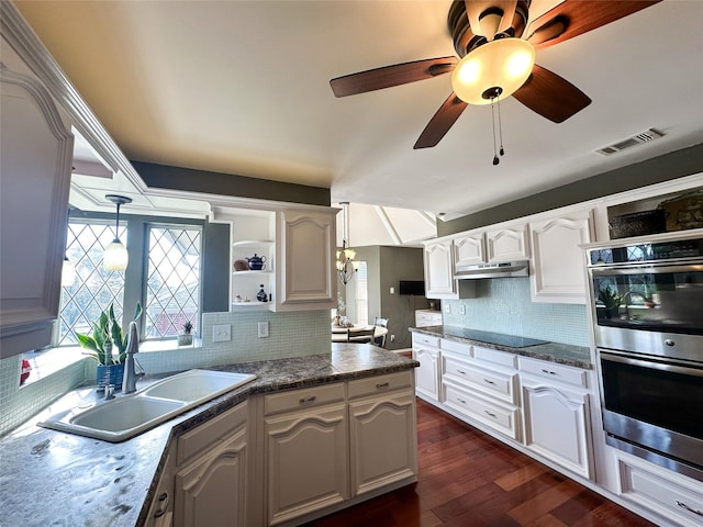 kitchen featuring pendant lighting, sink, dark hardwood / wood-style floors, double oven, and white cabinetry