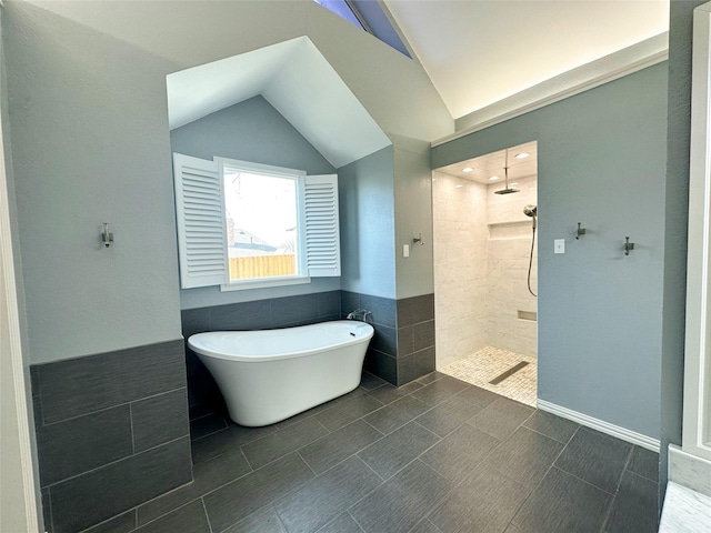 bathroom featuring tile patterned flooring, shower with separate bathtub, and lofted ceiling