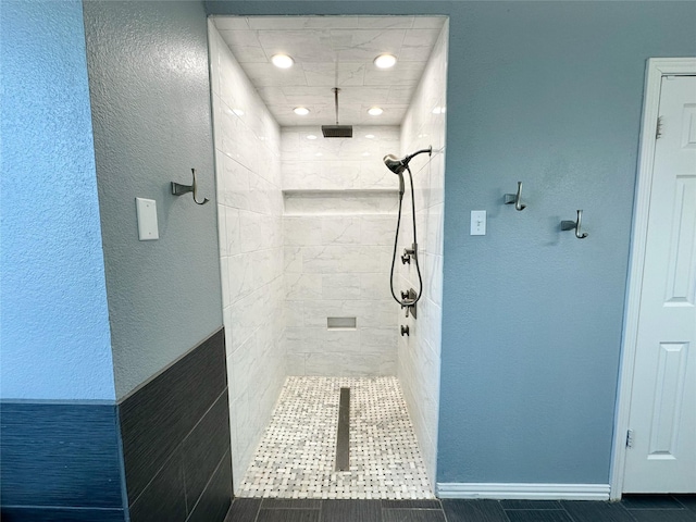 bathroom featuring tile patterned floors and tiled shower