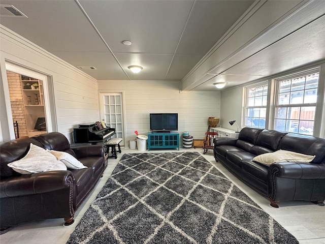 living room with wooden walls and ornamental molding