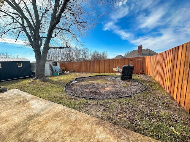 view of yard with a storage shed and a patio