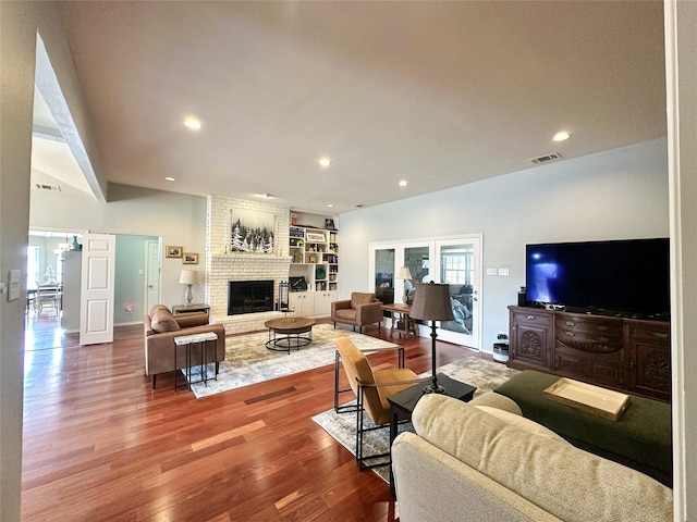 living room with a fireplace and hardwood / wood-style flooring