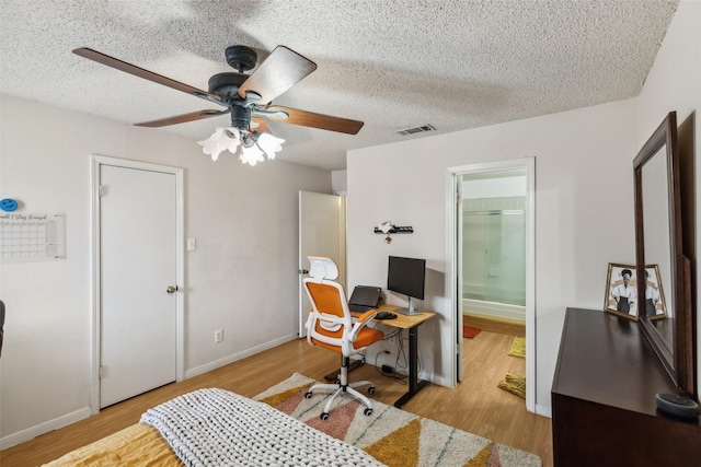 office area with a textured ceiling, light hardwood / wood-style floors, and ceiling fan