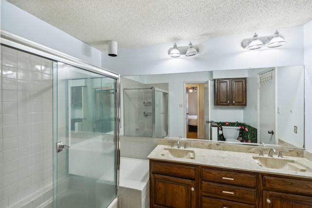 bathroom featuring a textured ceiling, vanity, an enclosed shower, and toilet