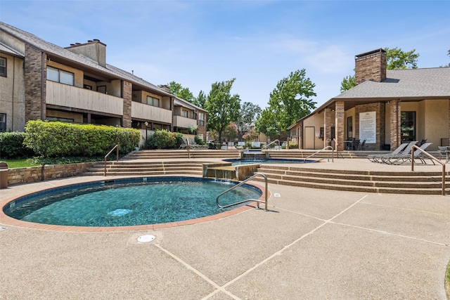 view of pool with pool water feature