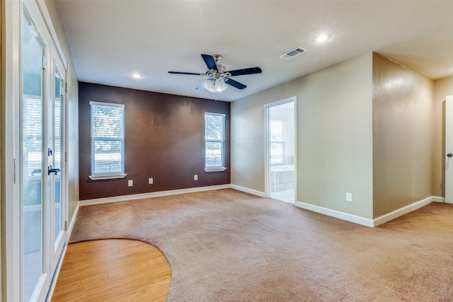 unfurnished room featuring ceiling fan and carpet