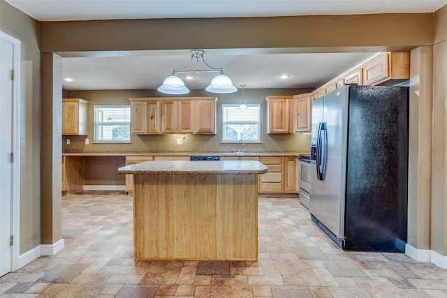 kitchen with a center island, stainless steel refrigerator with ice dispenser, light brown cabinetry, sink, and hanging light fixtures