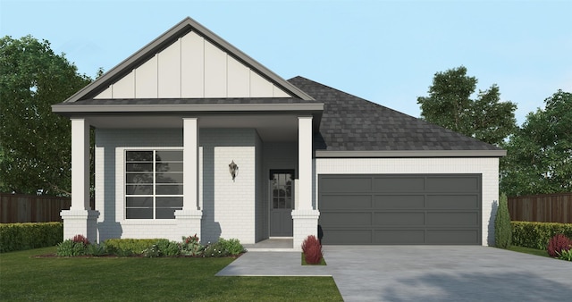 view of front of house featuring covered porch, a garage, and a front yard