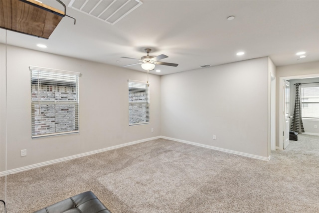 spare room featuring carpet floors and ceiling fan