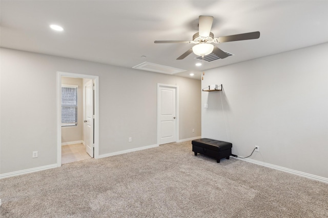 empty room featuring ceiling fan and light colored carpet