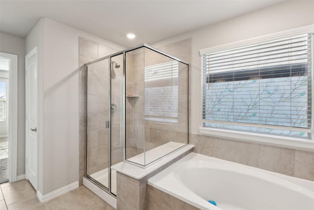 bathroom featuring tile patterned floors, plenty of natural light, and shower with separate bathtub