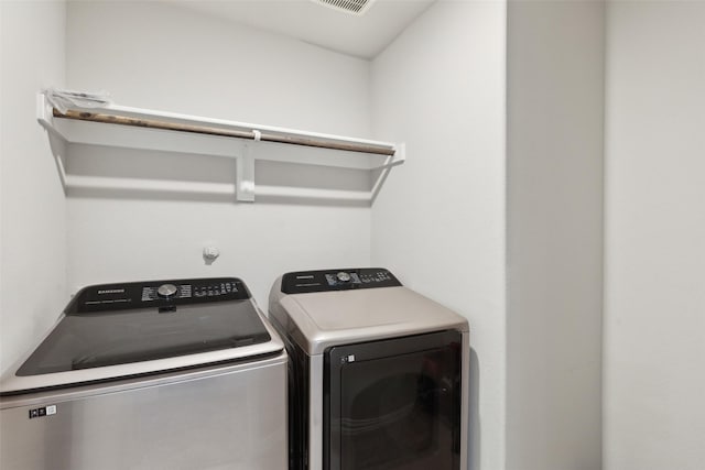 clothes washing area featuring washer and clothes dryer