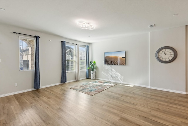 unfurnished room featuring light hardwood / wood-style floors and a wealth of natural light