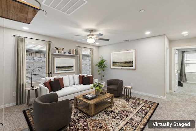 carpeted living room with ceiling fan