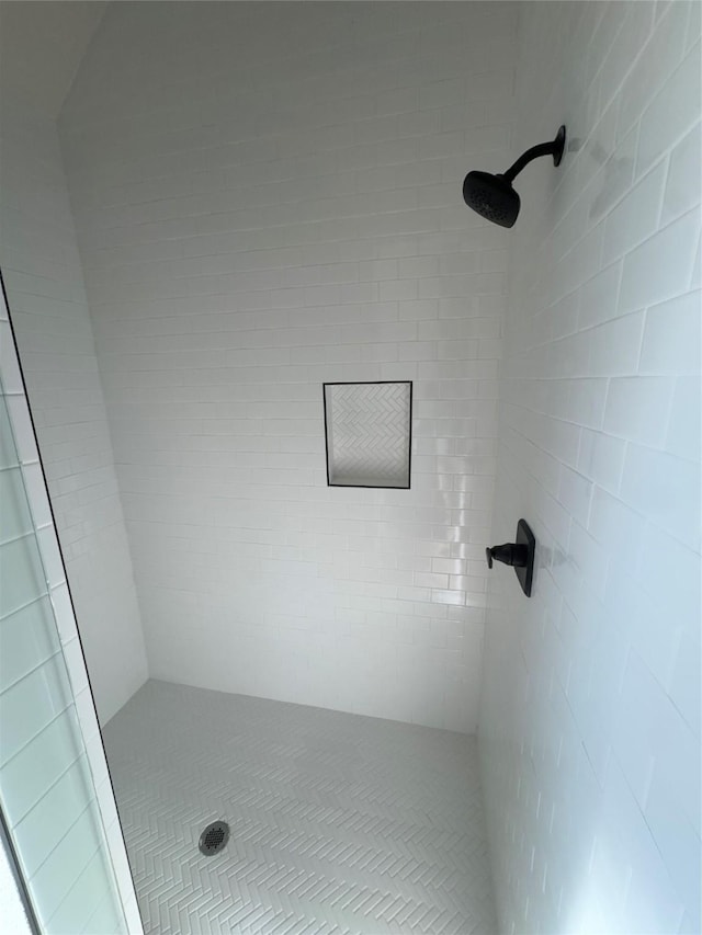 bathroom with a tile shower