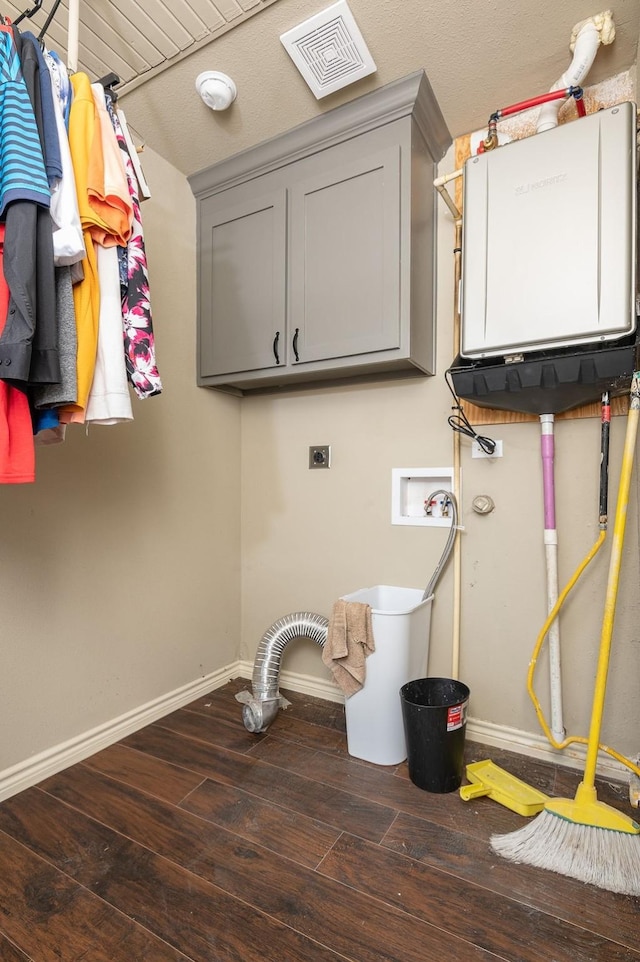 clothes washing area with cabinets, hookup for an electric dryer, dark wood-type flooring, and washer hookup