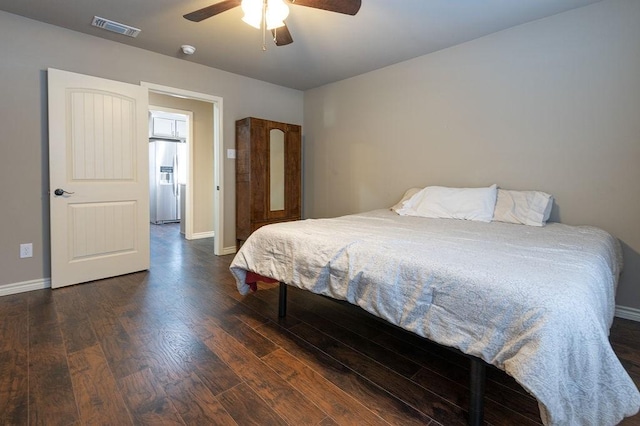 bedroom with stainless steel fridge with ice dispenser, dark hardwood / wood-style flooring, and ceiling fan