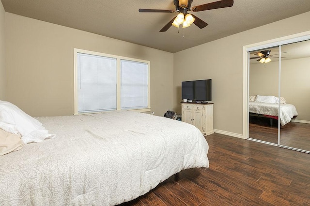 bedroom featuring dark wood-type flooring, a closet, and ceiling fan