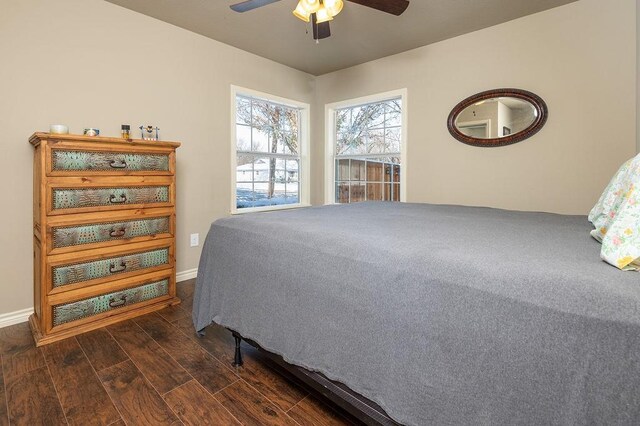 bedroom with dark hardwood / wood-style flooring, a closet, and ceiling fan