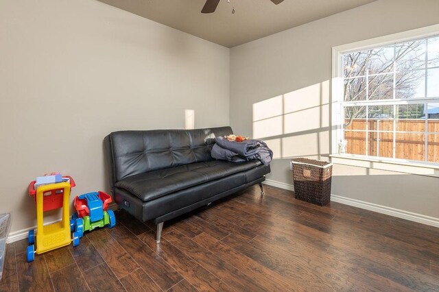 living room featuring dark hardwood / wood-style floors and ceiling fan