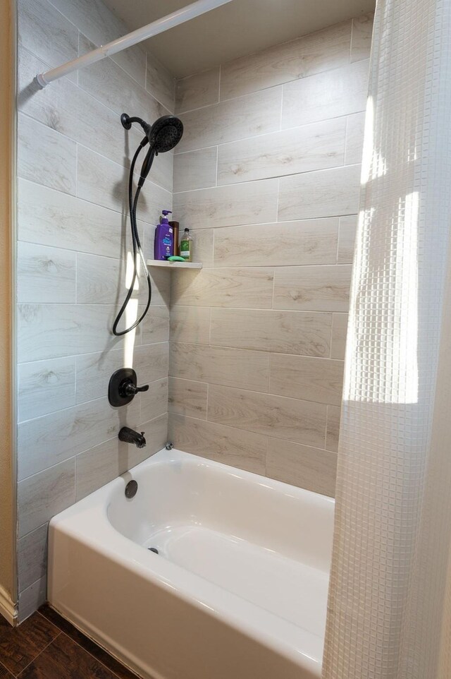 bathroom featuring hardwood / wood-style flooring, vanity, and tiled shower / bath