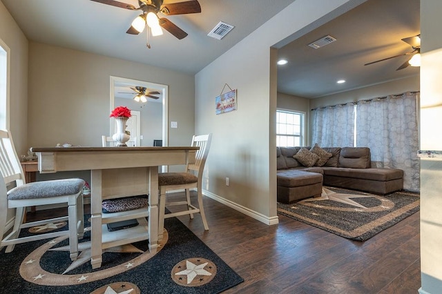 dining area with dark wood-type flooring and ceiling fan