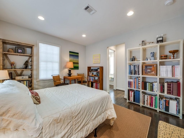 bedroom with dark wood-style flooring, visible vents, and recessed lighting