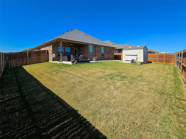 view of yard featuring a storage unit and a patio